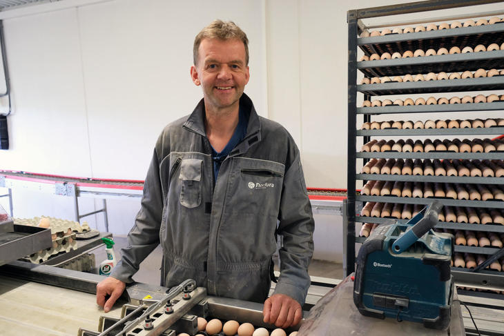 Bilde av styreleder Johan Narum i Nortura. Han er kledd i grå arbeidsdress med Norturas logo, står inne i eggpakkeriet på gården sin. I bakgrunn ser vi et stativ med rugegg.